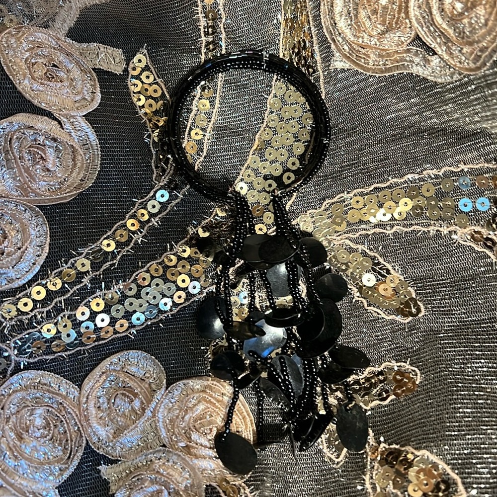 Interesting black beaded bracelet with long tassels